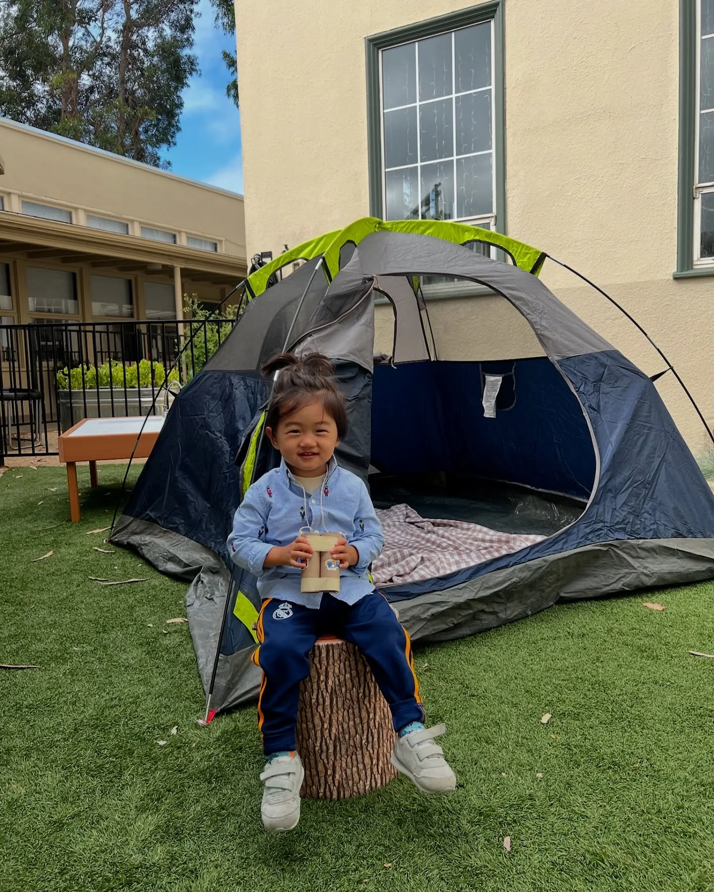 UMC Preschool child enjoying imaginative outdoor camping play